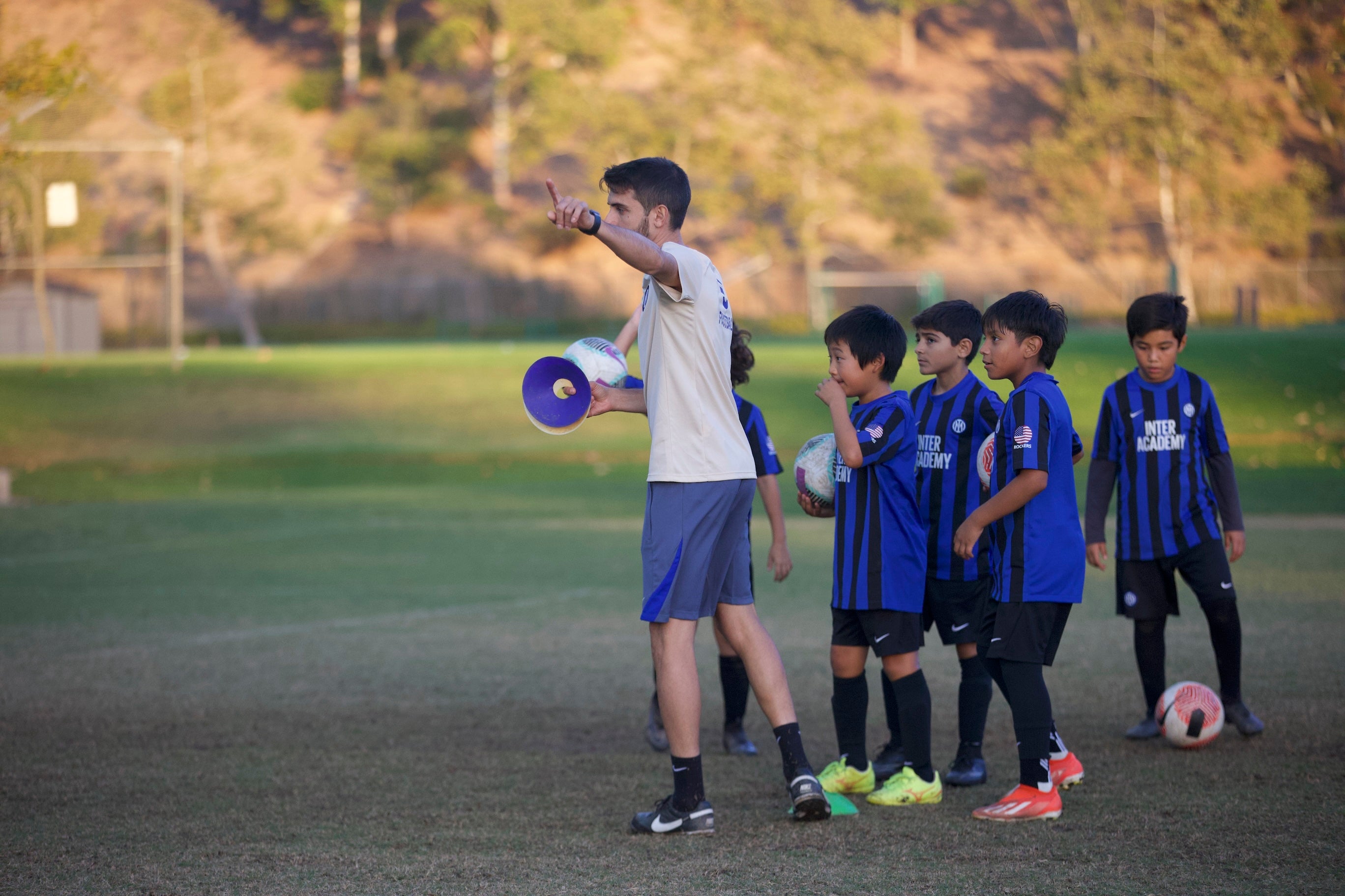 coach giving direction to soccer players